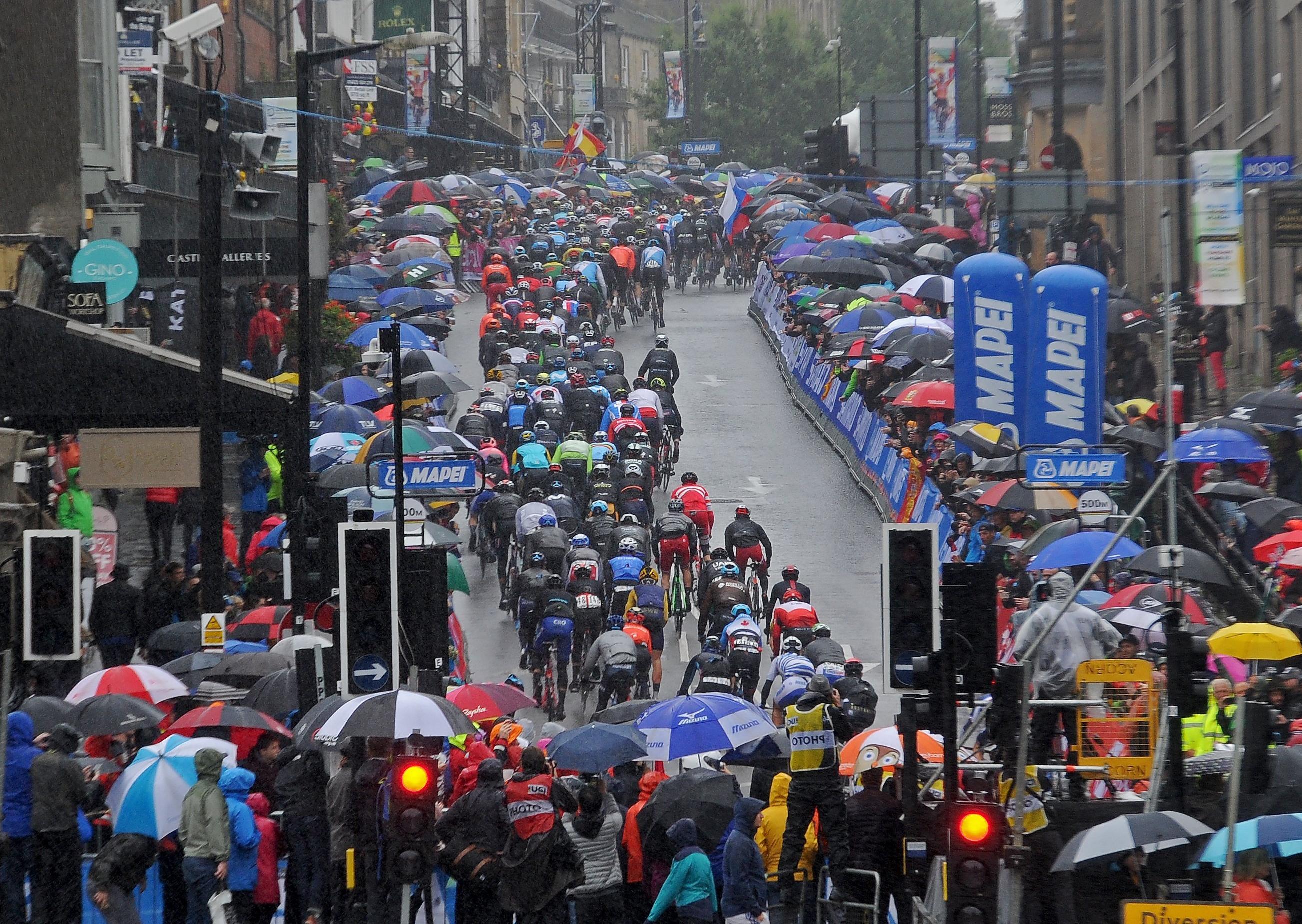 29 September 2019......    Spectators watch the Men's Elite road race  in heavy rain in Harrogate.