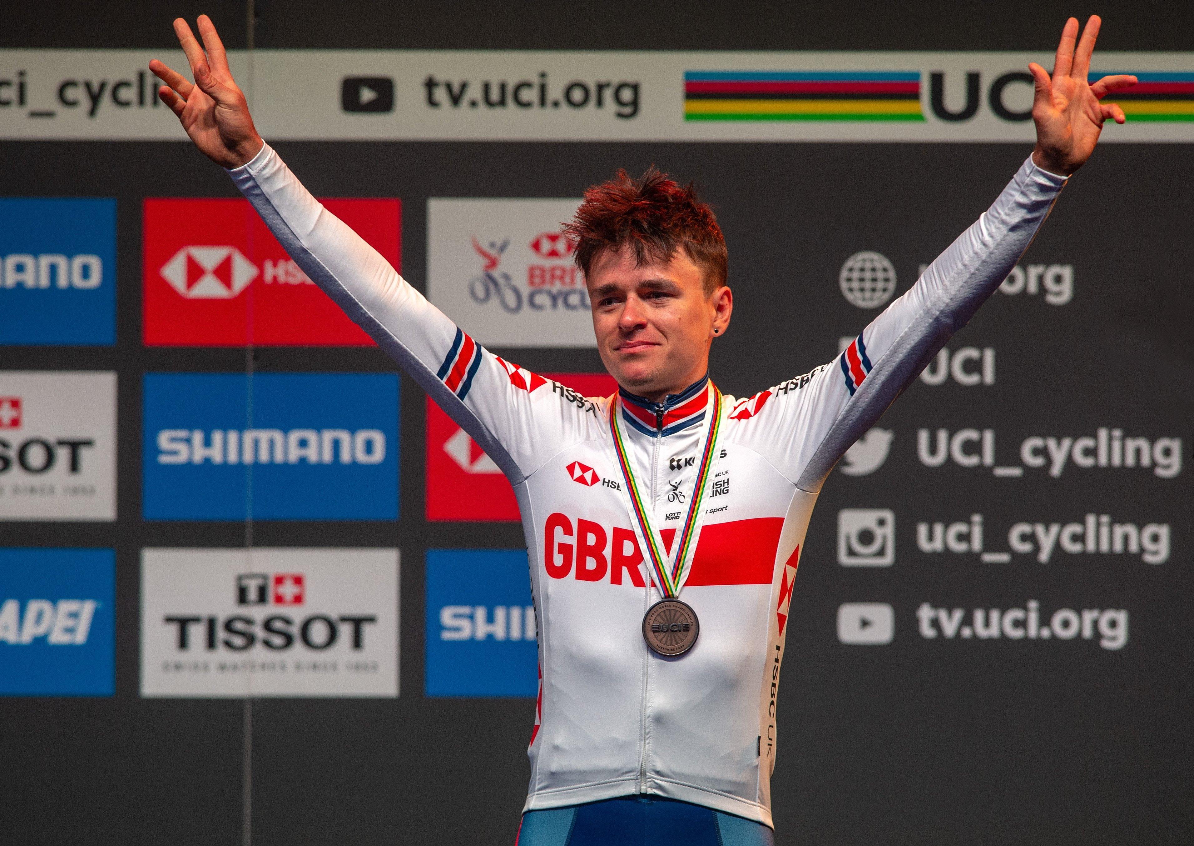 Tom Pidcock celebrates his bronze medal in the Under-23s men's road race.