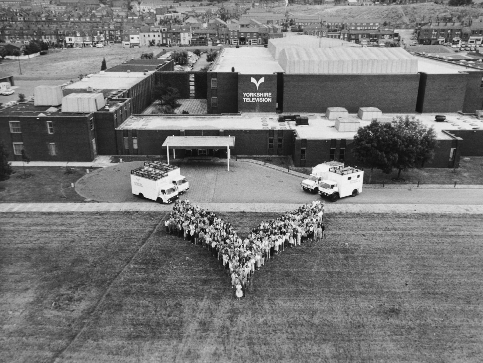 Employees of Yorkshire Television line up outside their premises on Kirkstall Road in the shape of the YTV emblem.