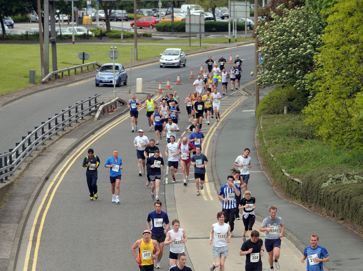 Action from the Leeds Half Marathon, Junior and Fun Run. The runners make their way from Kirkstall Road up towards The Headrow.