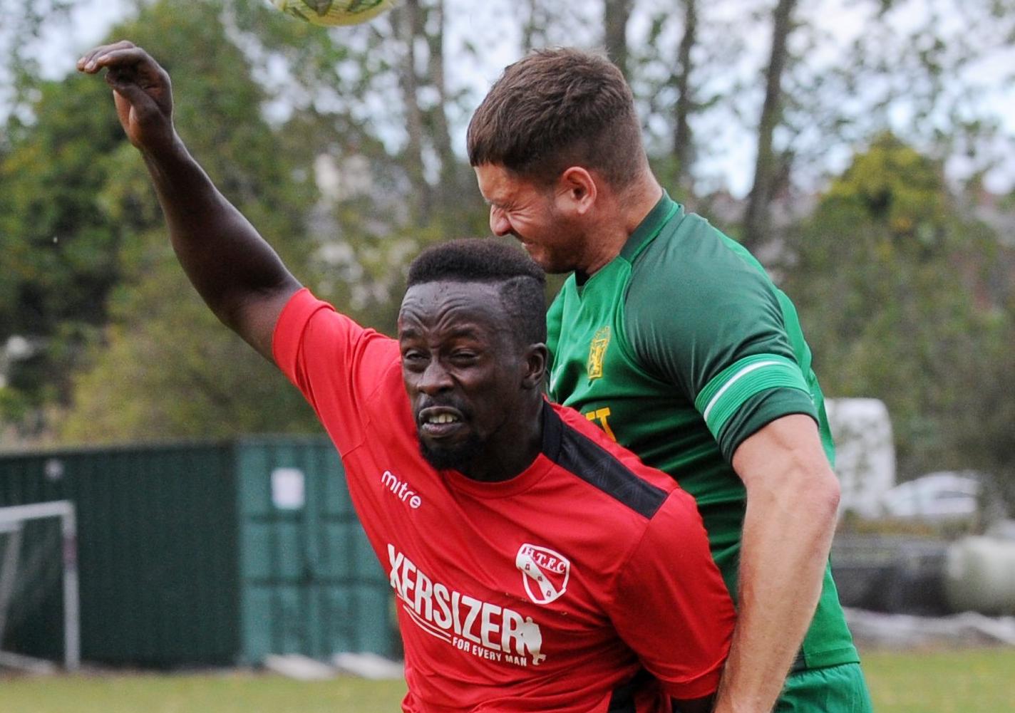Ryan Grant of Hunslet Club beats Gibril Bojang of Horbury Town to the ball.