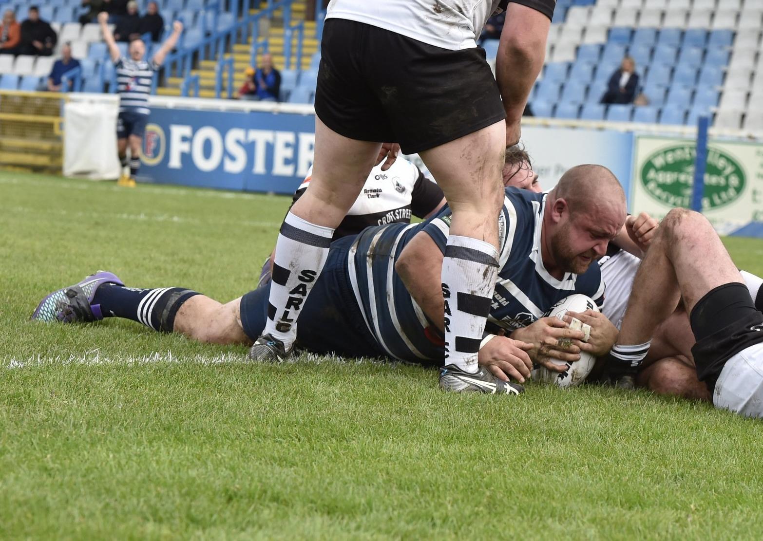 Danny Gilbert wrestles the ball over the try line. PIC: © RFL/Matthew Merrick Photography