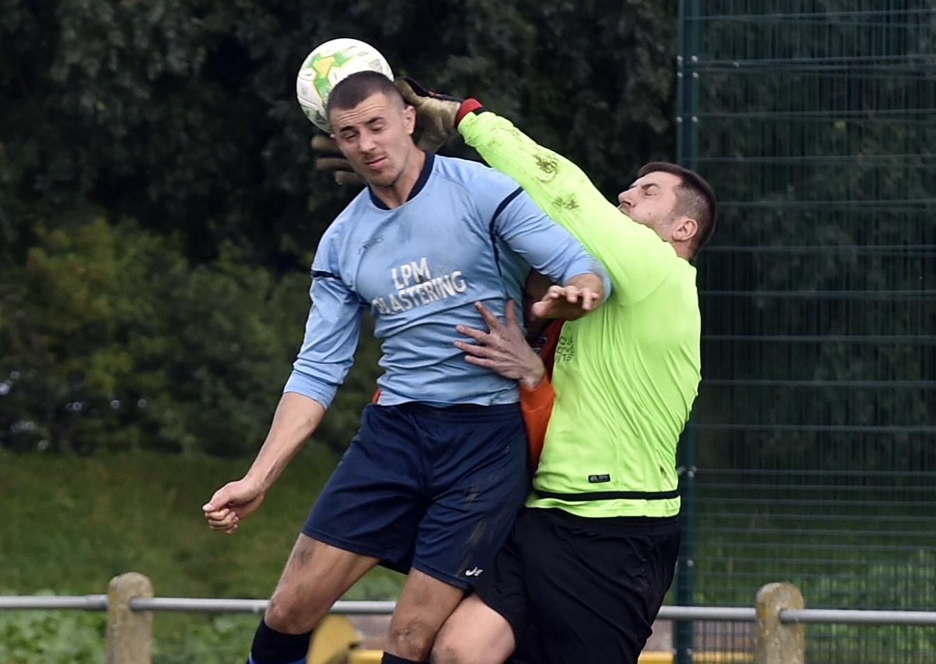 Wetherby Athletic goalkeeper Darren Hooper collects the ball ahead of Aberford's Liam Parker.