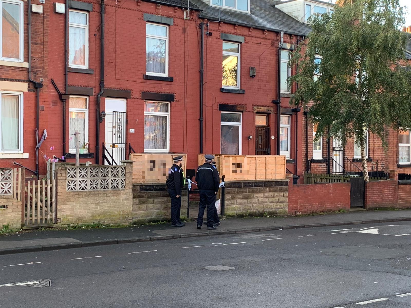 Police at a house in Harehills after a chemical substance was thrown during a burglary