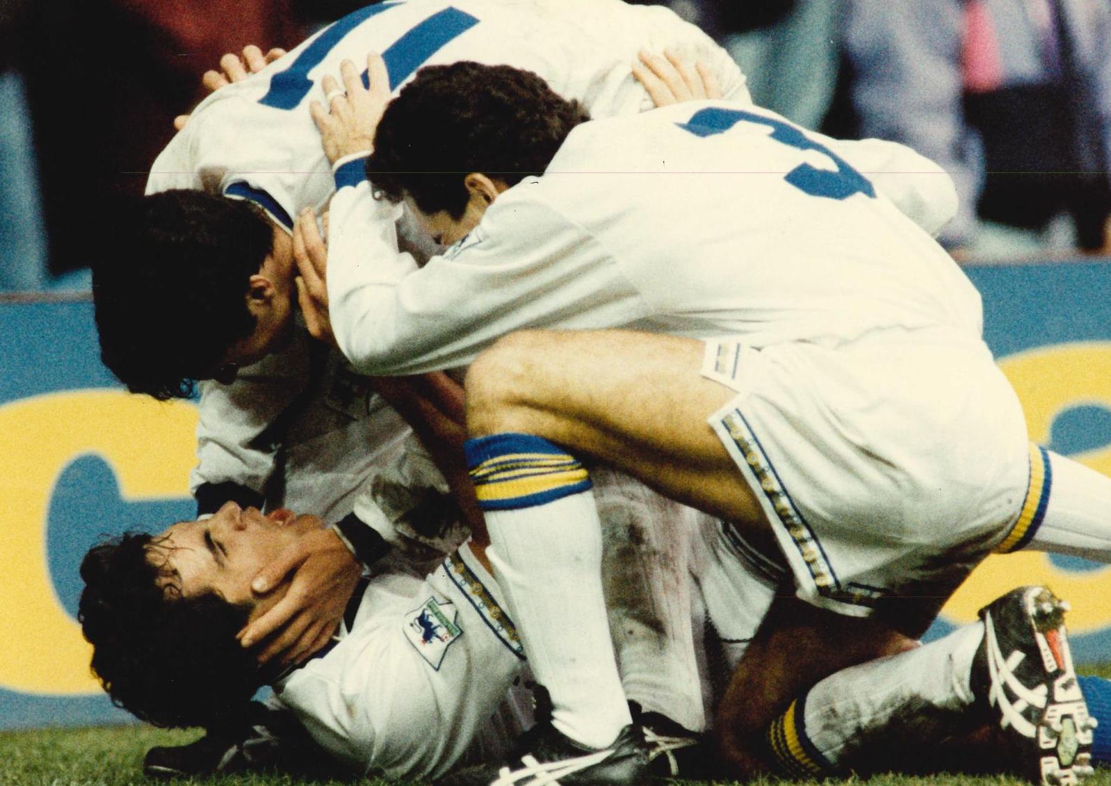 Frank Strandli is mobbed by Gary Speed and Tony Dorigo after scoring on his debut.