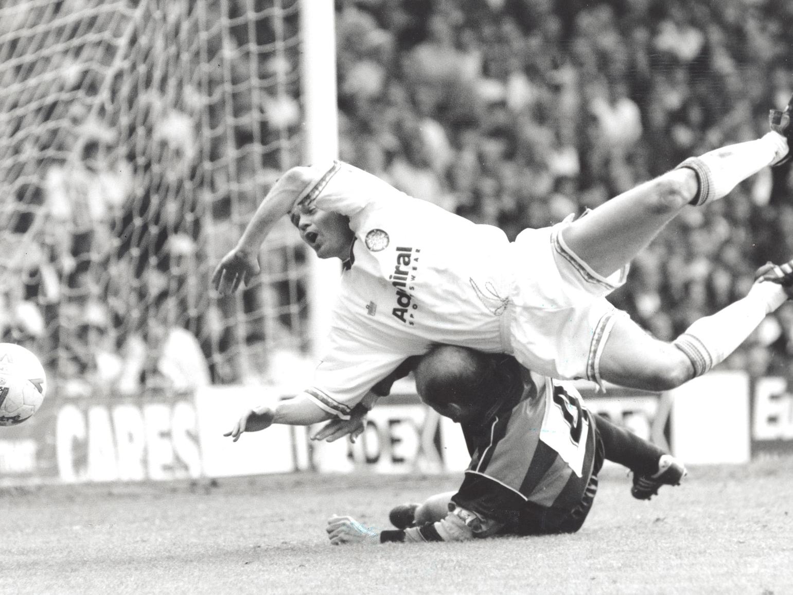 Steve Hodge tumbles to the ground on top of Ray Wilkins.
