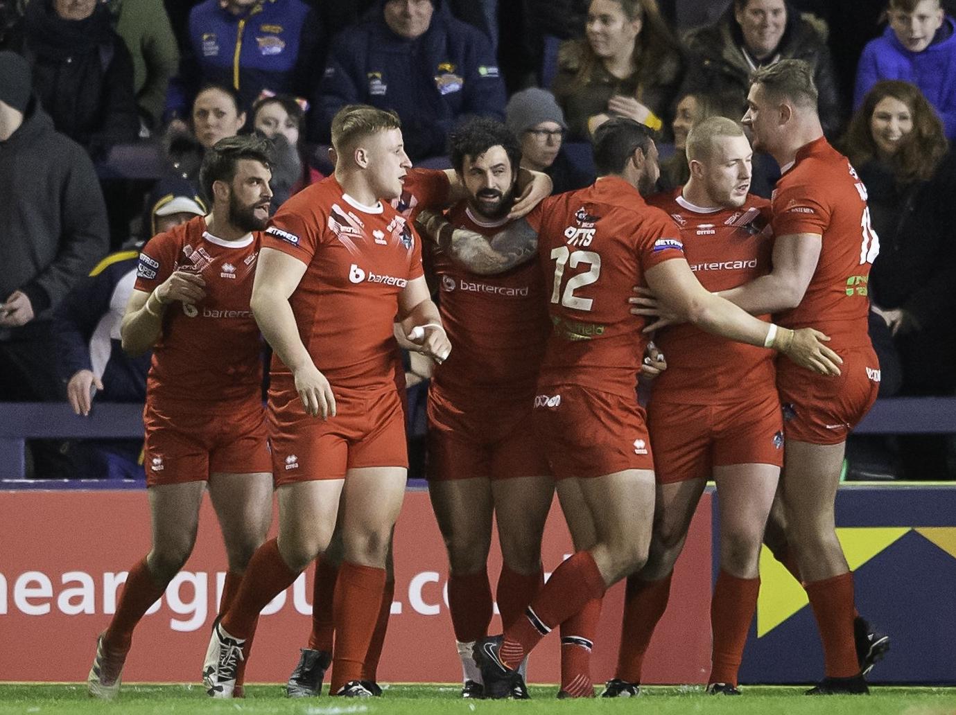 Jay Pitts, centre, celebrates scoring for London Broncos.