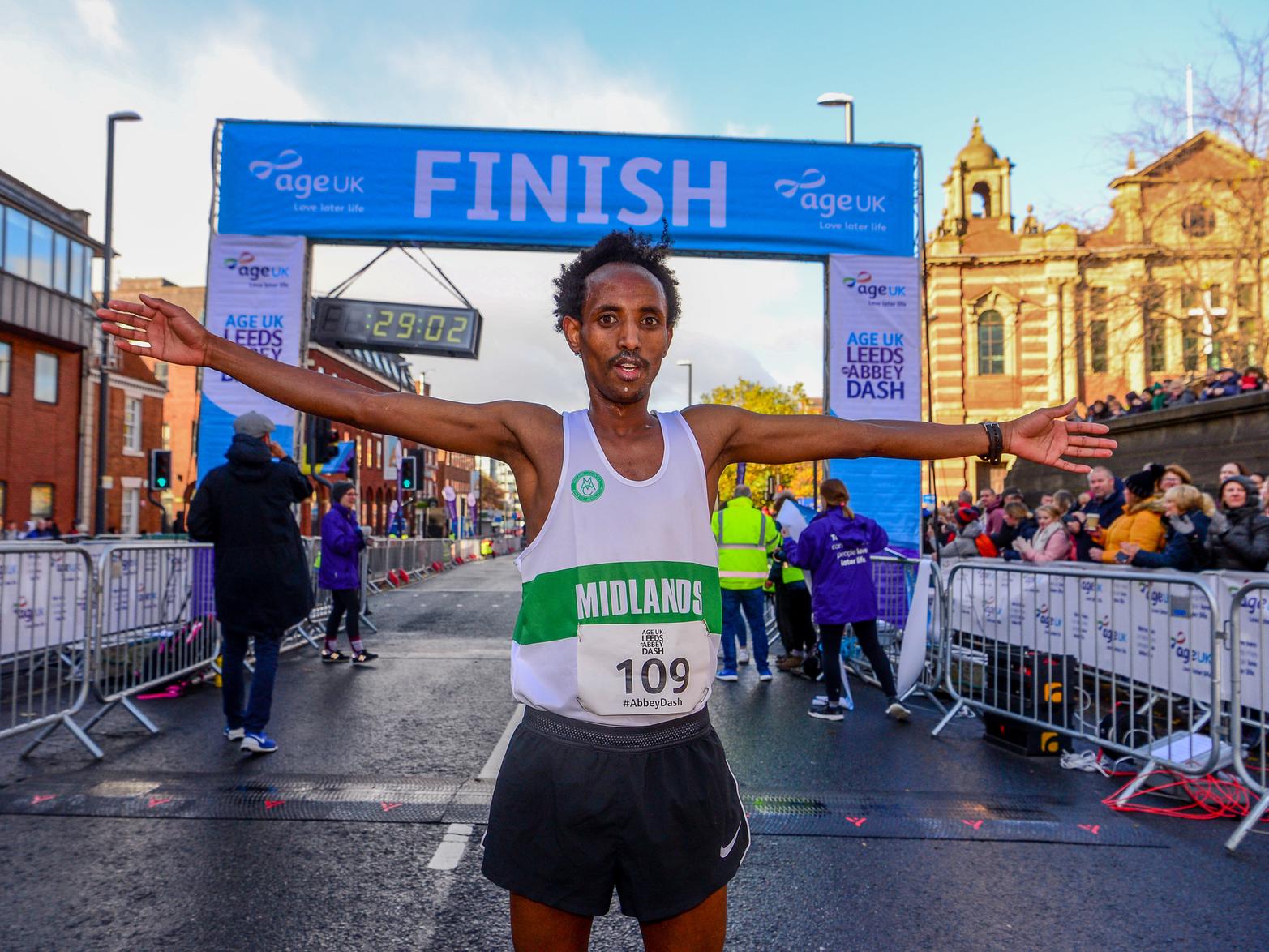 First male runner Omar Ahmed crossing the finishing line.