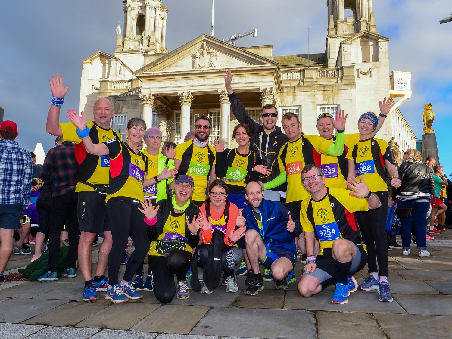 A group of runners stop for a photograph outside Leeds Civic Hall.