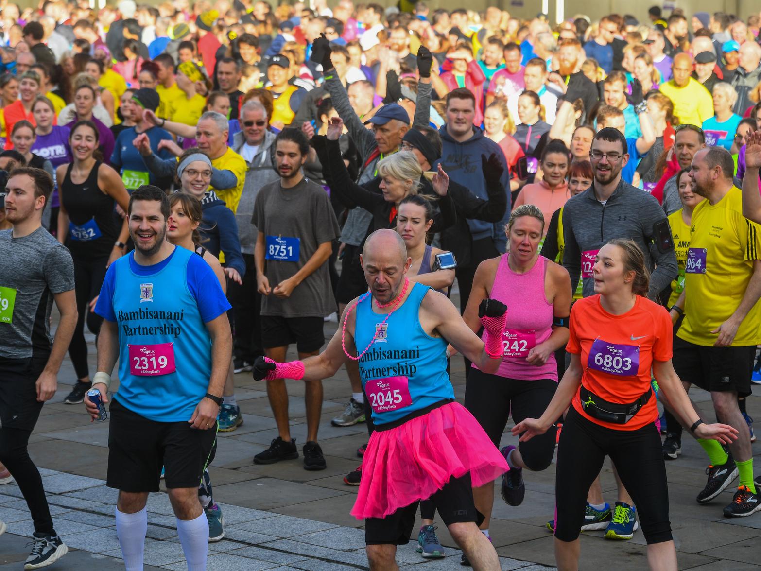 Runners warming up with some exercising in Millennium Square.