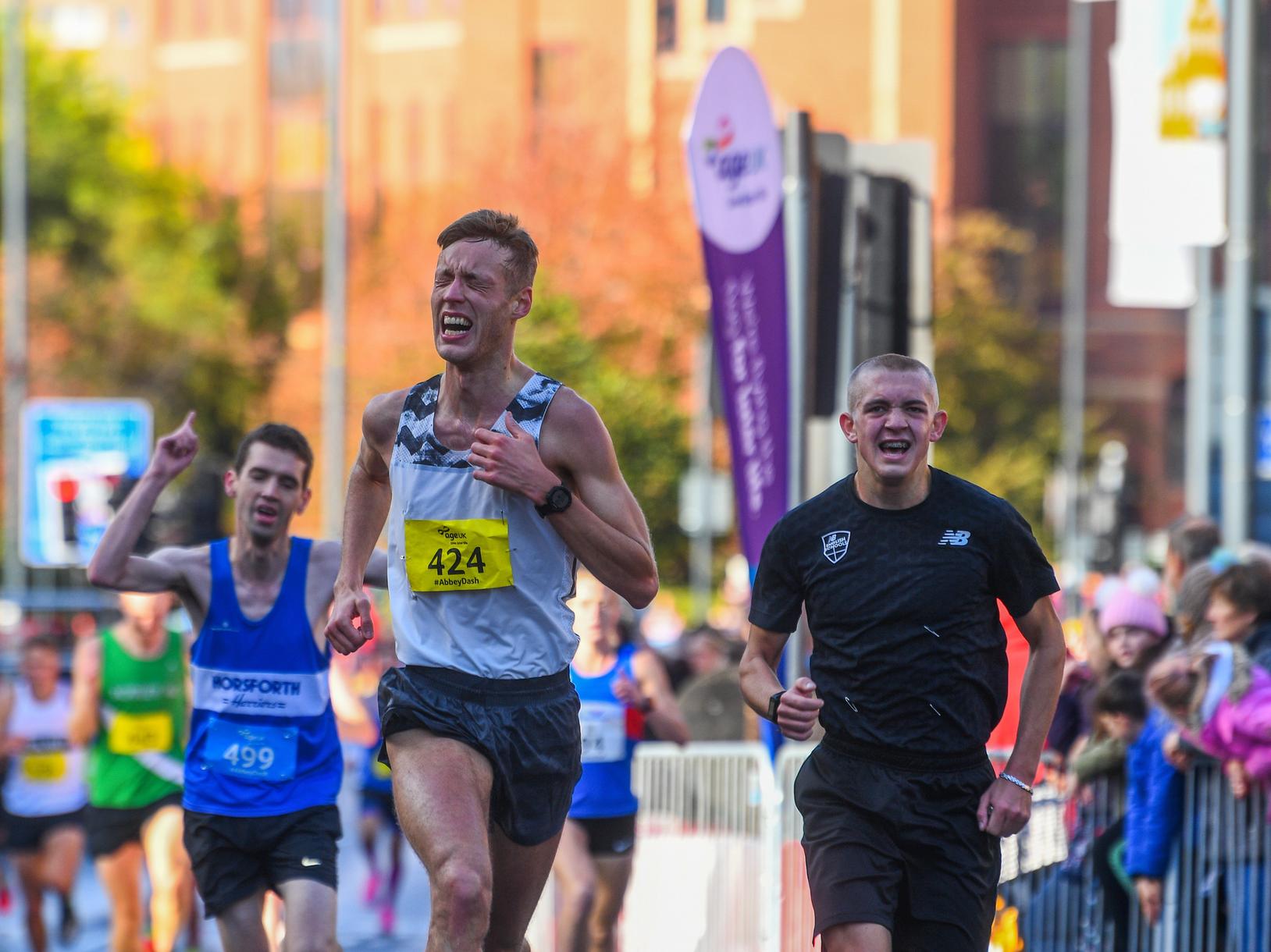Runners sprint towards the finish line.