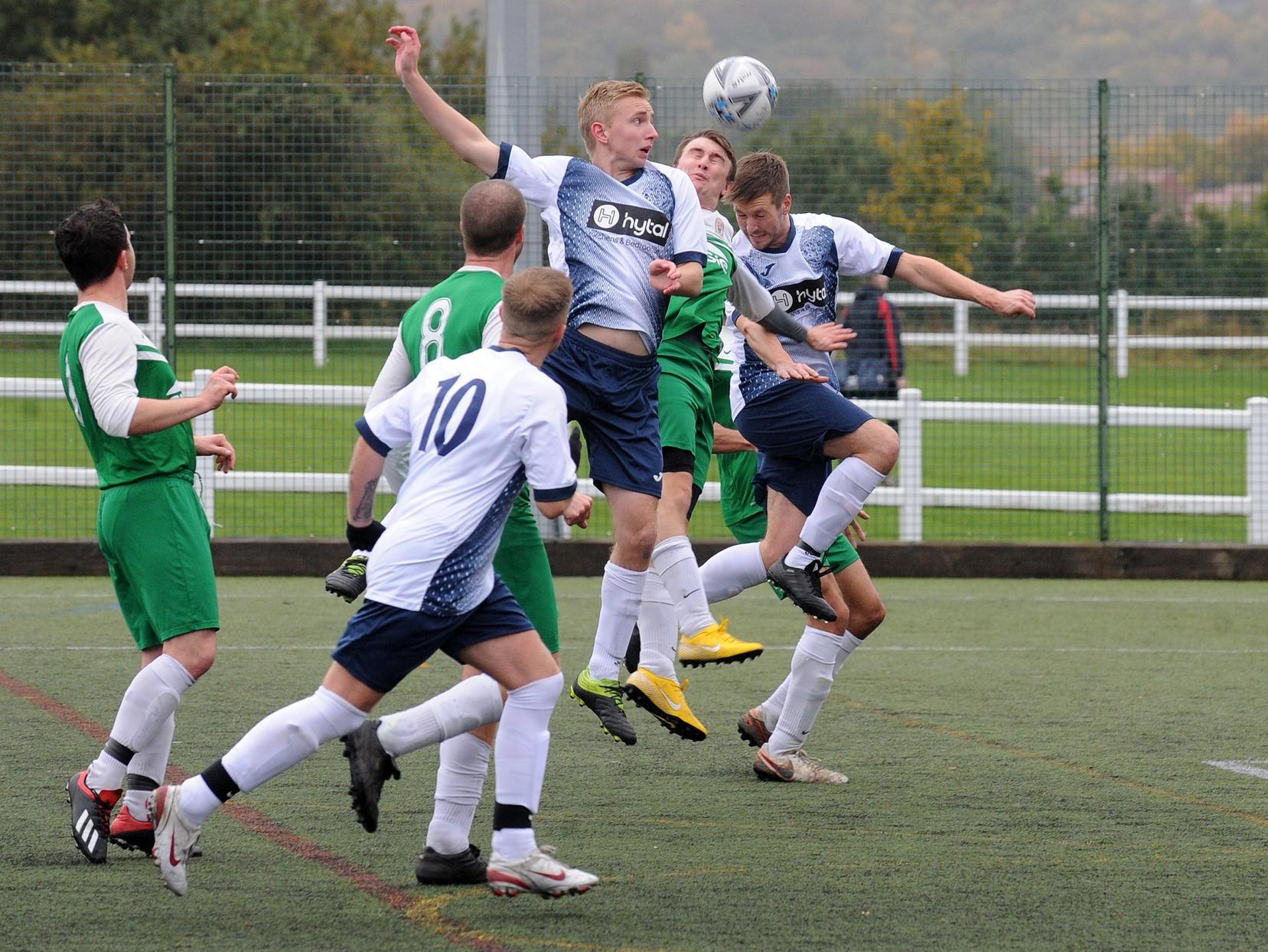 Daniel Holland heads goalwards for Morley Town against Trinity.