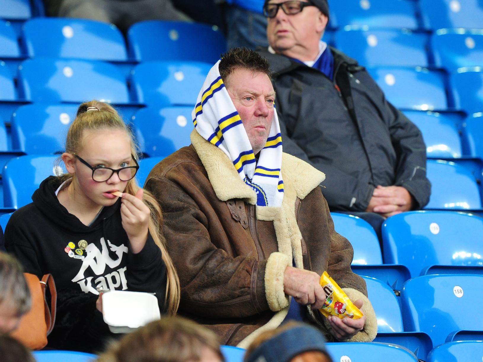 These two fans tuck into some snacks during the game.