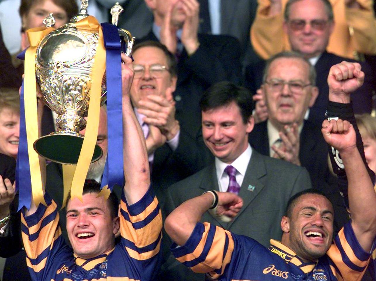 Leeds Rhinos Iestyn Harris and  man of the match Leroy Rivett lift the Challenge Cup after beating London Broncos 52-16 in the final at Wembley.