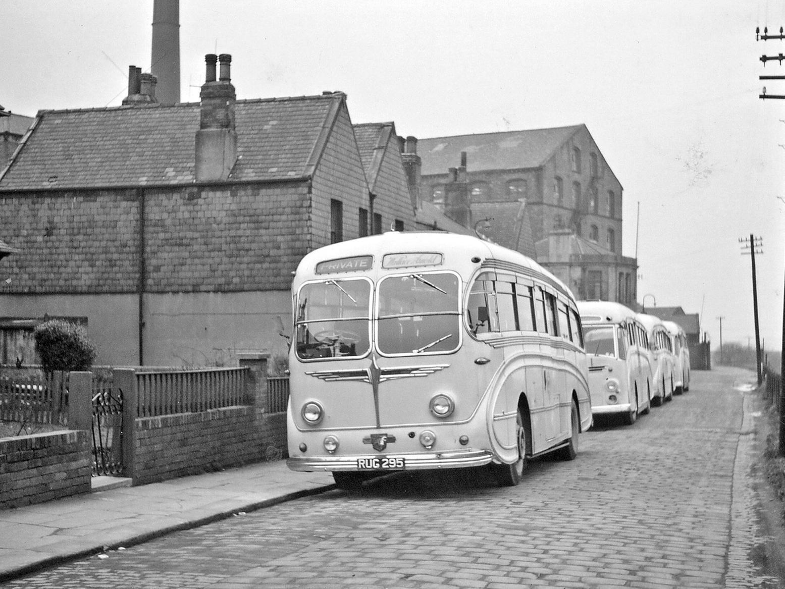Wallace Arnold coaches waiting outside Springfield Mills for female workers.