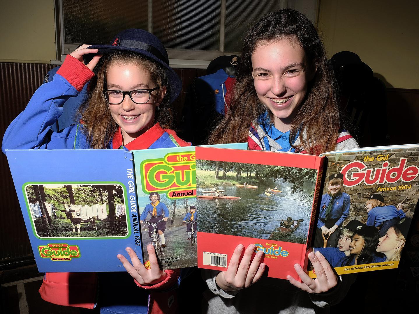 Erin and Leah Sutcliffe read some vintage 1980's guide annuals. Picture by Richard Ponter