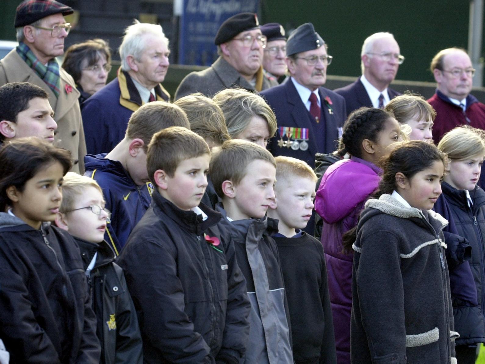 Pupils watch intently the remembrance service held by the school at the war memorial in Armley Park.