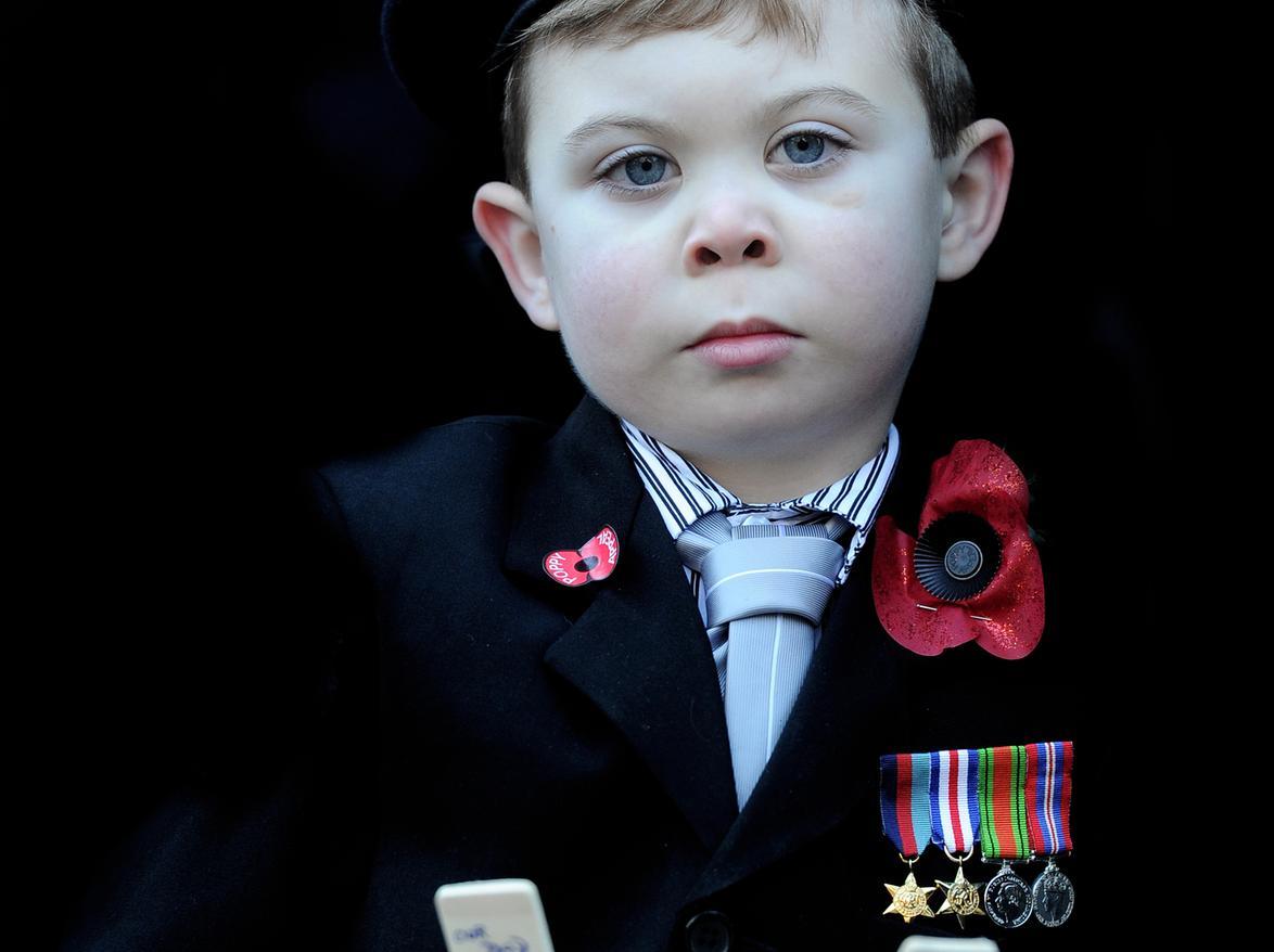 Harvey Roberts, five, wearing medals belonging to his great great grandad and great grandad during the service in Leeds city centre..
