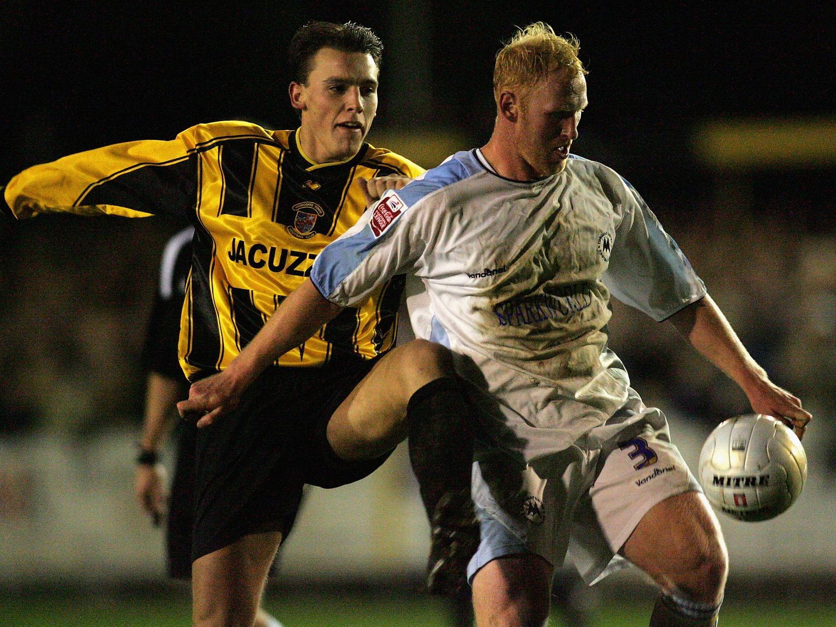 Harrogate Town's Danny Holland challenges James Sharp during the FA Cup first round replay clash with Torquay United at Wetherby Road on November 15, 2005.