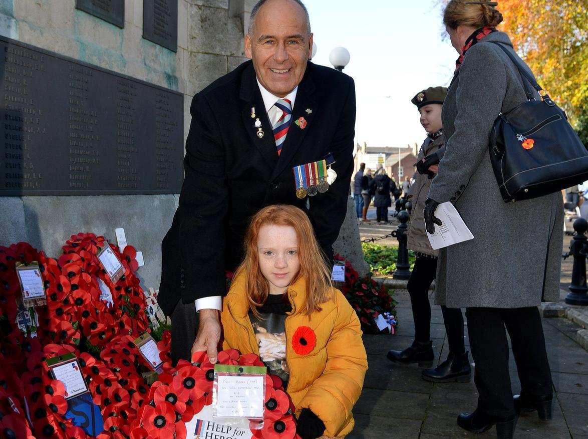 Tony Eaton lays a wreath with Izzie Bennett, eight, great granddaughter of  veteran Ken Beard who died earlier this year.