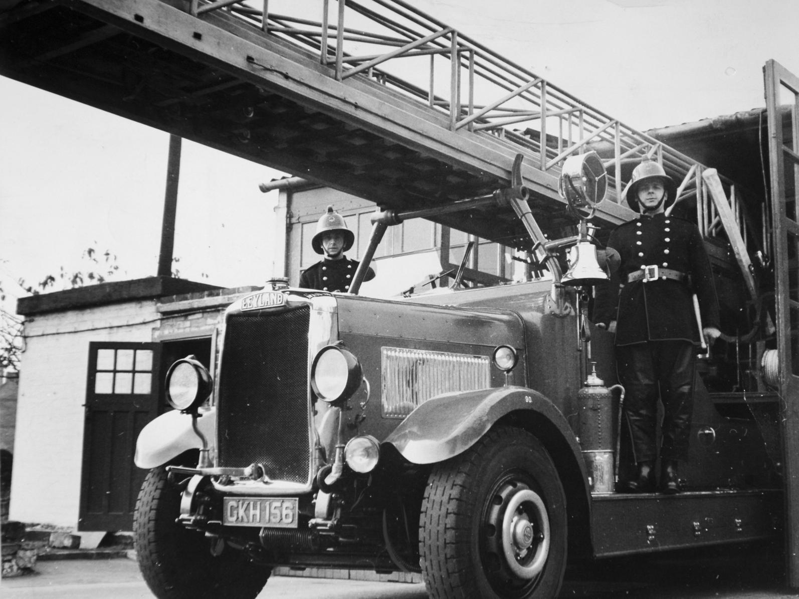 Members of Dewsbury Fire Brigade stand by a 22 year old turntable fire engine. The fire engine saw service in Hull during the Nazi blitz and was damaged by shrapnel.