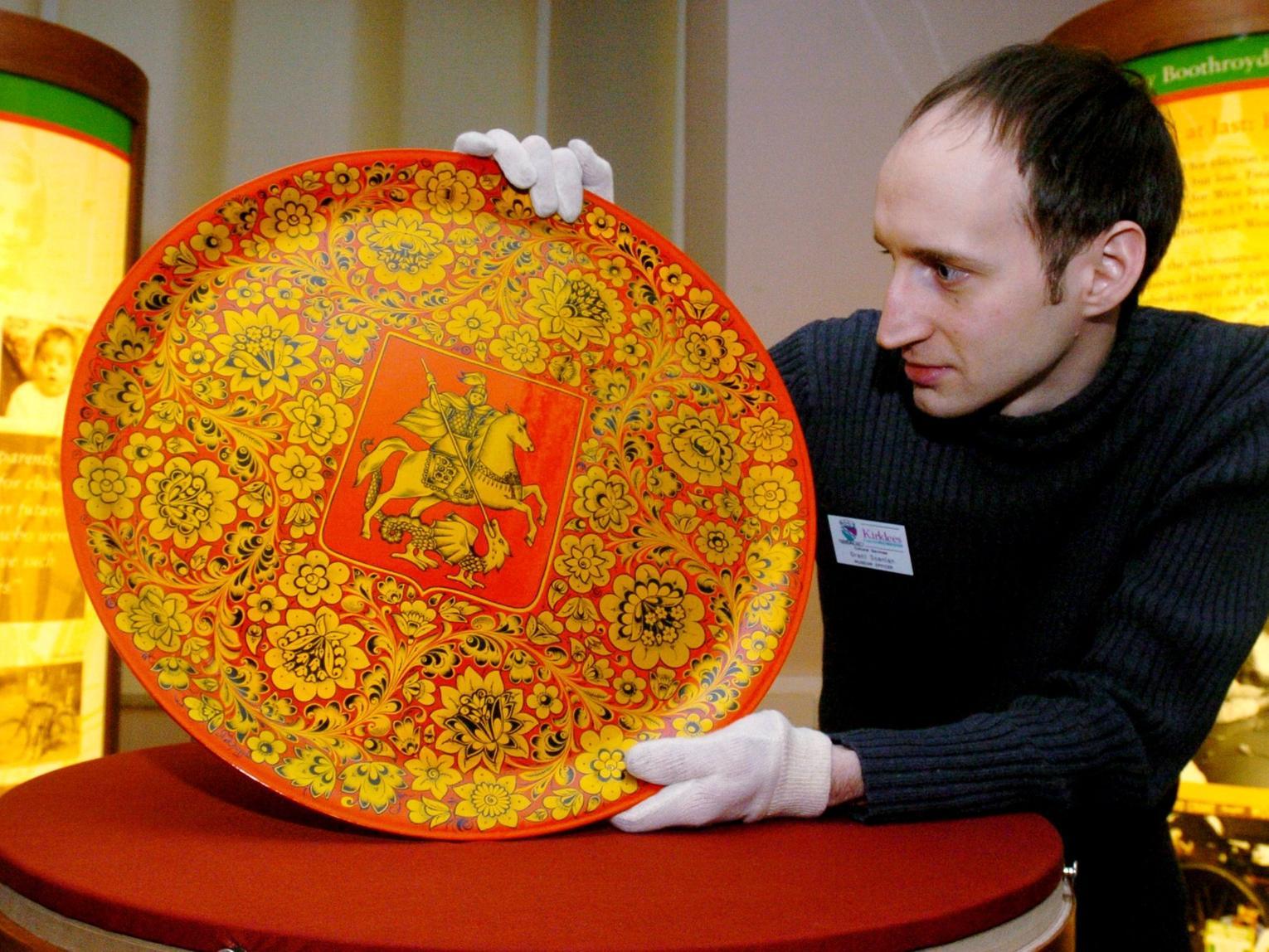 Grant Scanlon, museum officer of Dewsbury Museum, with a decorative papier mache plate presented to Betty Boothroyd by the Mayor of Moscow in October 1998.
