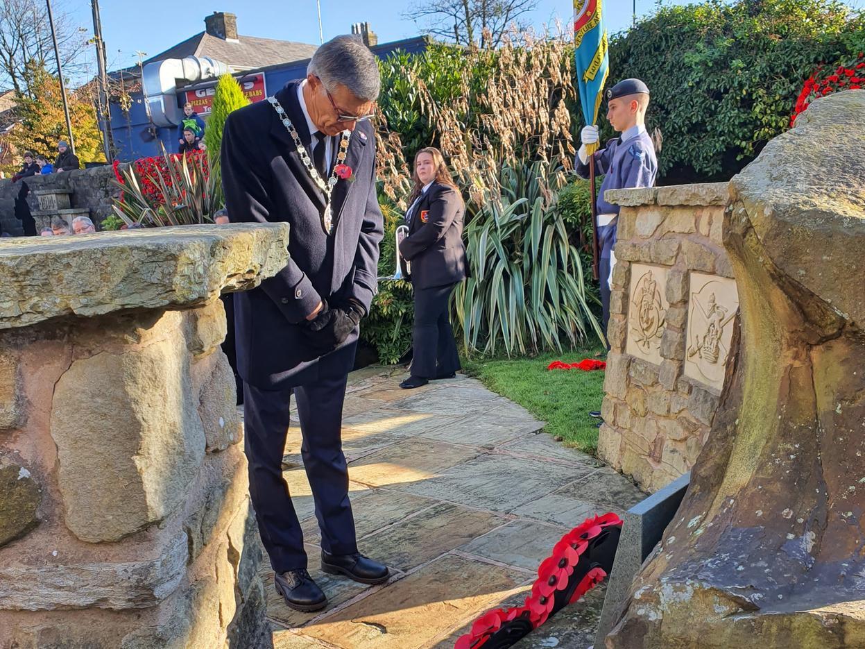 Town mayor Steve Ashcroft bows his head at the Longridge Memorial Gardens