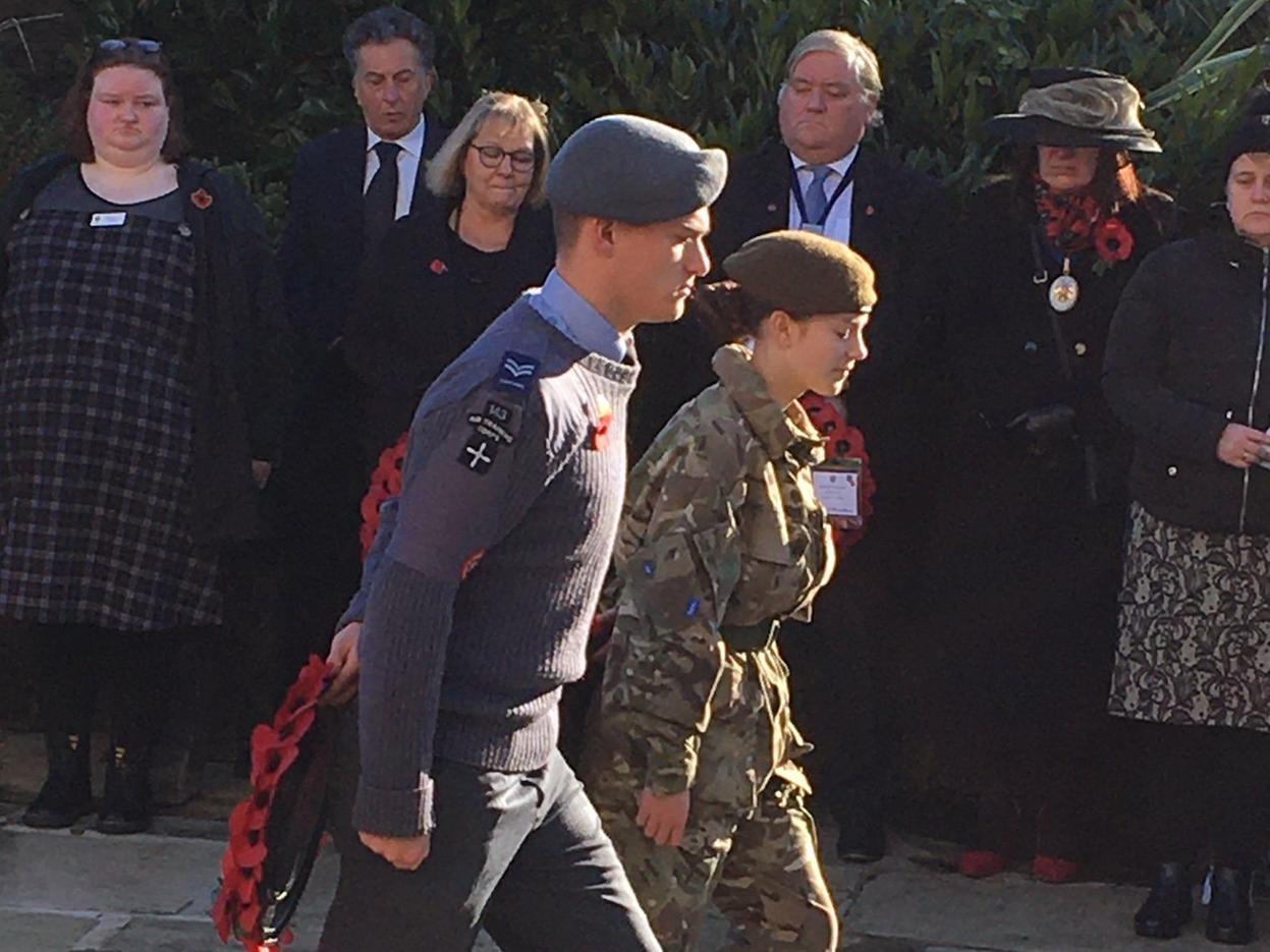 A solemn moment as  young uniformed organisation representatives step forward to lay wreaths