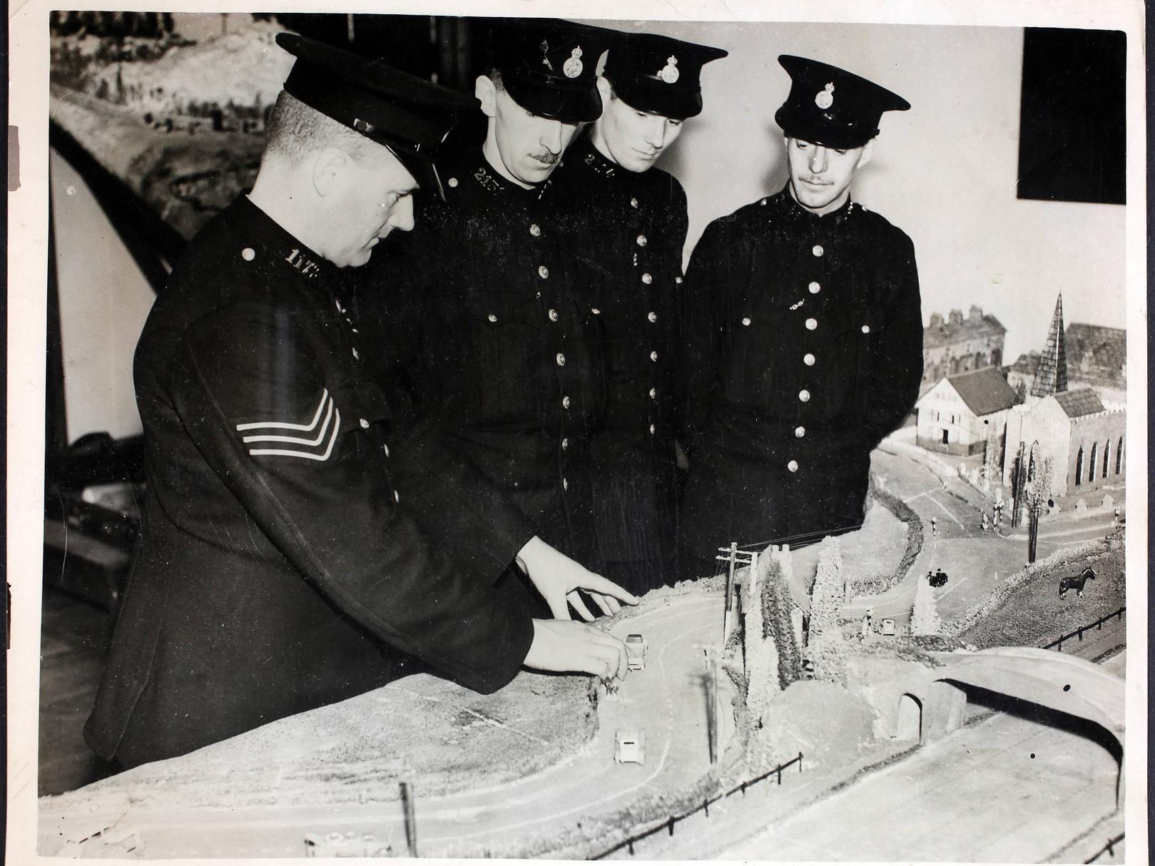 Recruits using full-size working models of cars, and a scale model of a roadway to learn about road safety