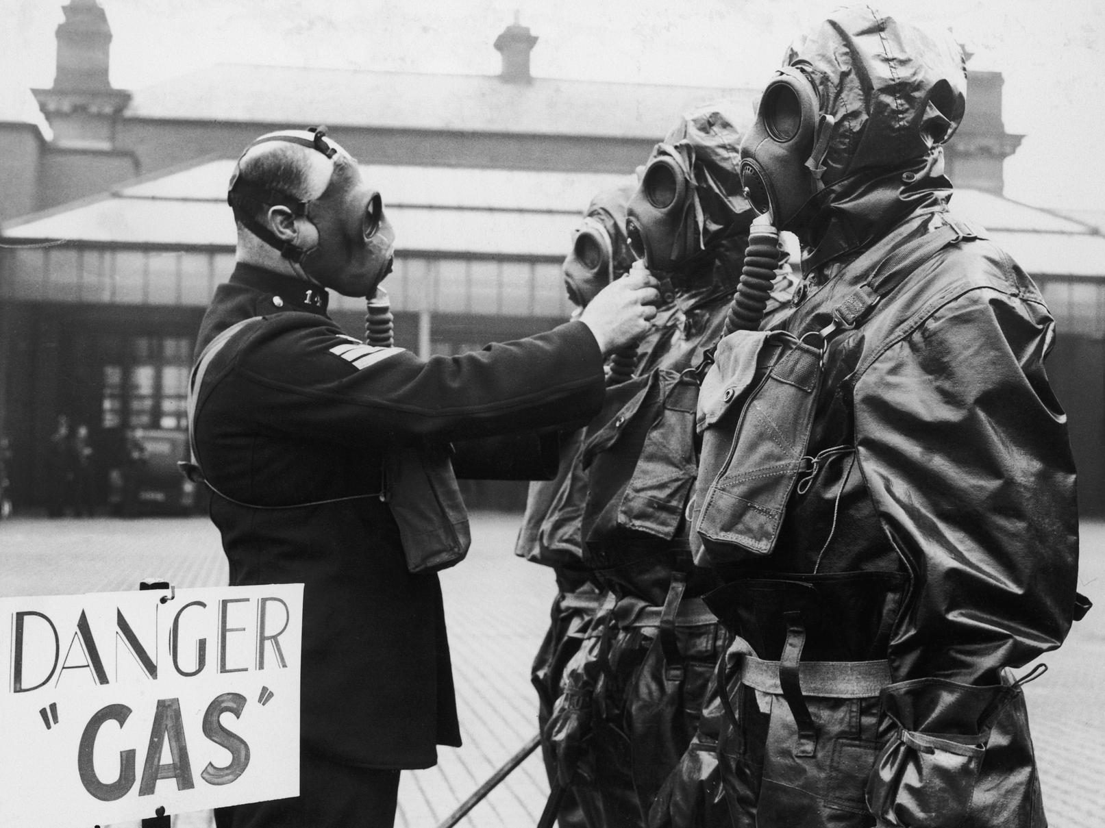 Sgt Taylor adjusting his constables gas mask during a gas drill, in September 1936.