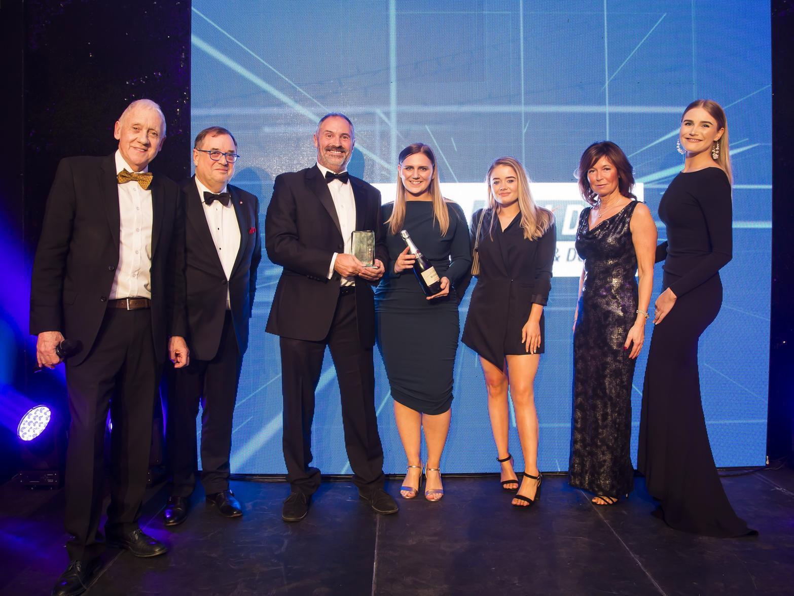 Overall Business of the Year. From the left, host Harry Gration, sponsor Roger Marsh, chairman of The Piece Hall Trust, and Winners the Quickslide team.