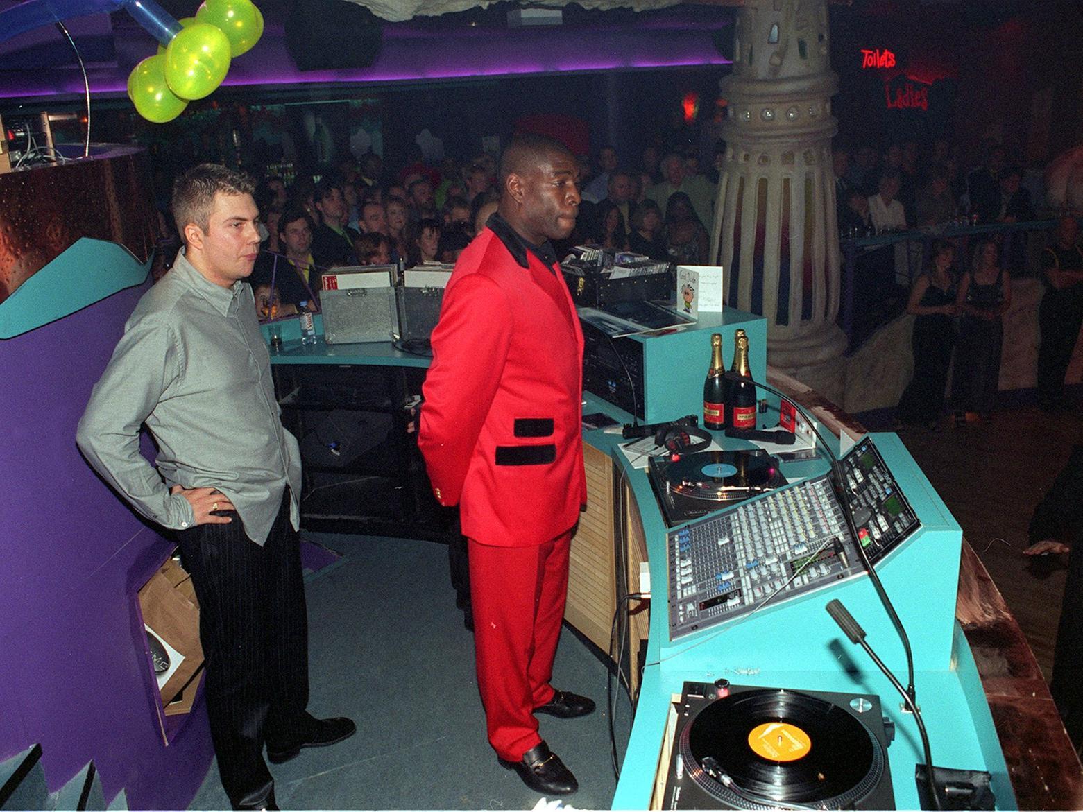 Frank Bruno addresses clubbers in the DJ booth.