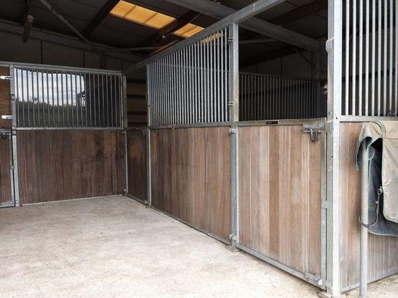 Alongside the equestian arena, the property also has stabling facilities.