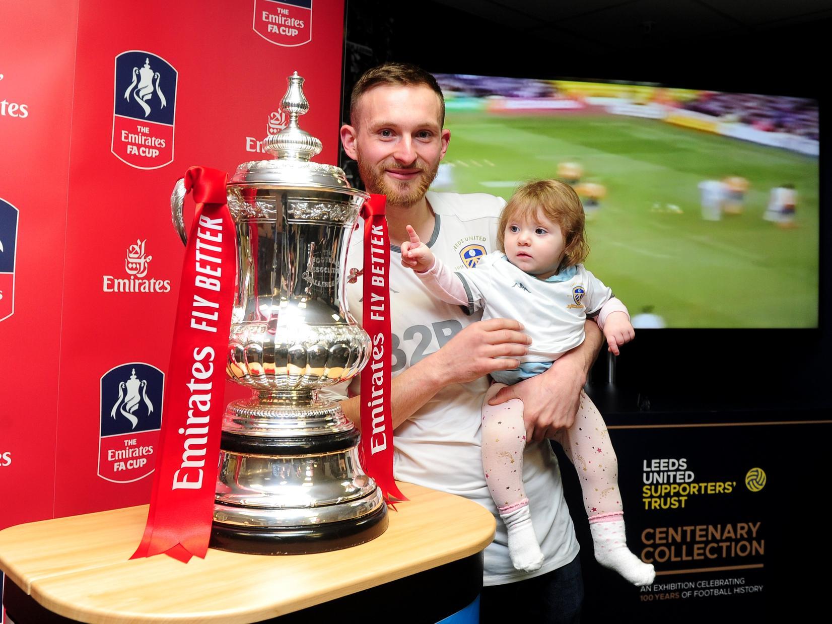 Dan Cole pictured with his daughter Daisy Cole aged 8 months - who wants a piece of the cup!