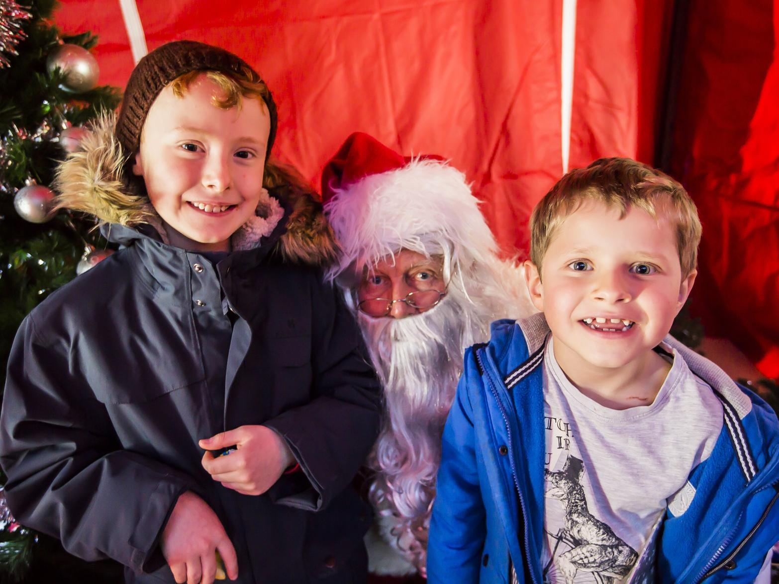 Luke Wade, nine, left, and Elliot Wade, six, with Father Christmas.