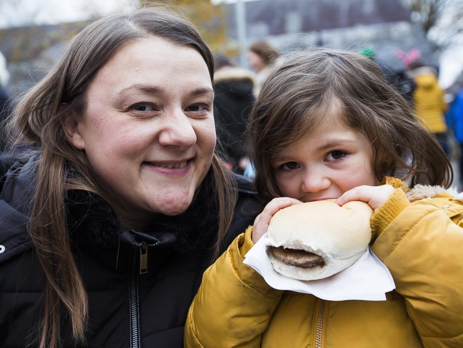 Nia Eccleston, four, tucks into a burger, with mum Victoria Eccleston at the annual Mytholmroyd event.
