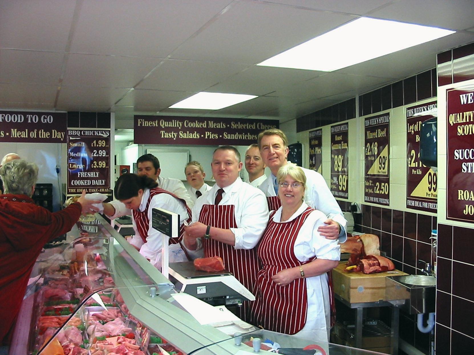 Colin Burgon MP, second right, in Duncan Firth's new butchers shop on Main Street, Garforth. Pictured with Duncan Firth, third right, and shop staff at official opening.