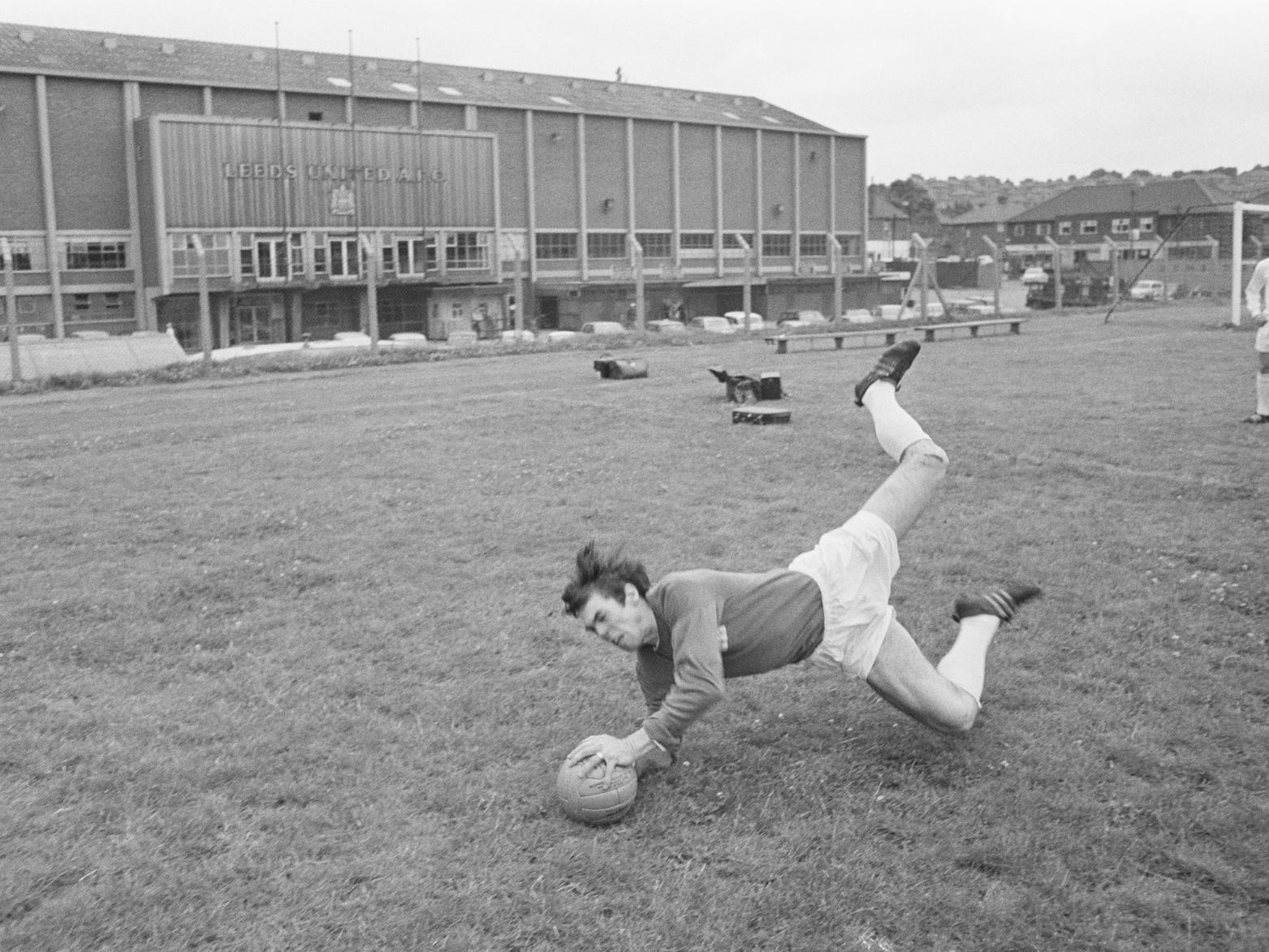 Goalkeeper David Harvey practices some shot-stopping outside of Elland Road during the 1960s.