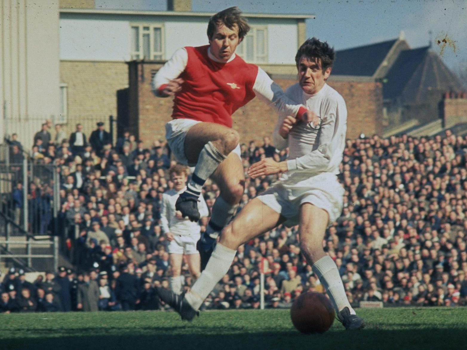 Norman Hunter (right) tackles an Arsenal player during a Division One match at Highbury Stadium.