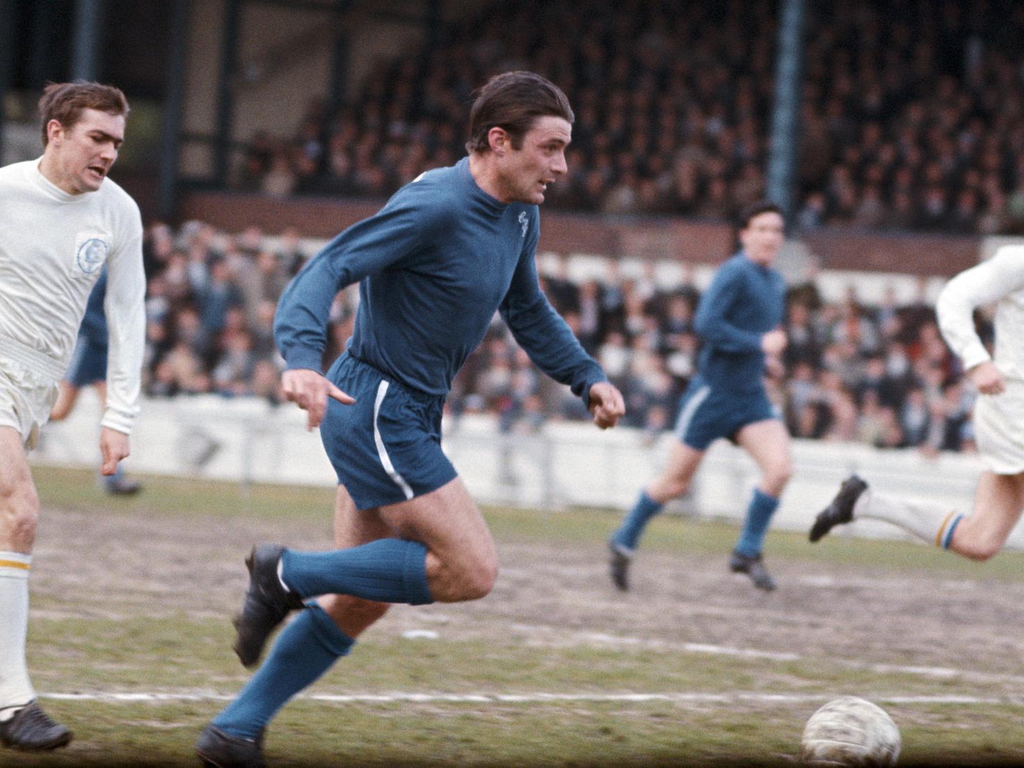 Chelsea forward Bobby Tambling (blue) sprints past Terry Cooper (white) during a First Division match at Stamford Bridge.