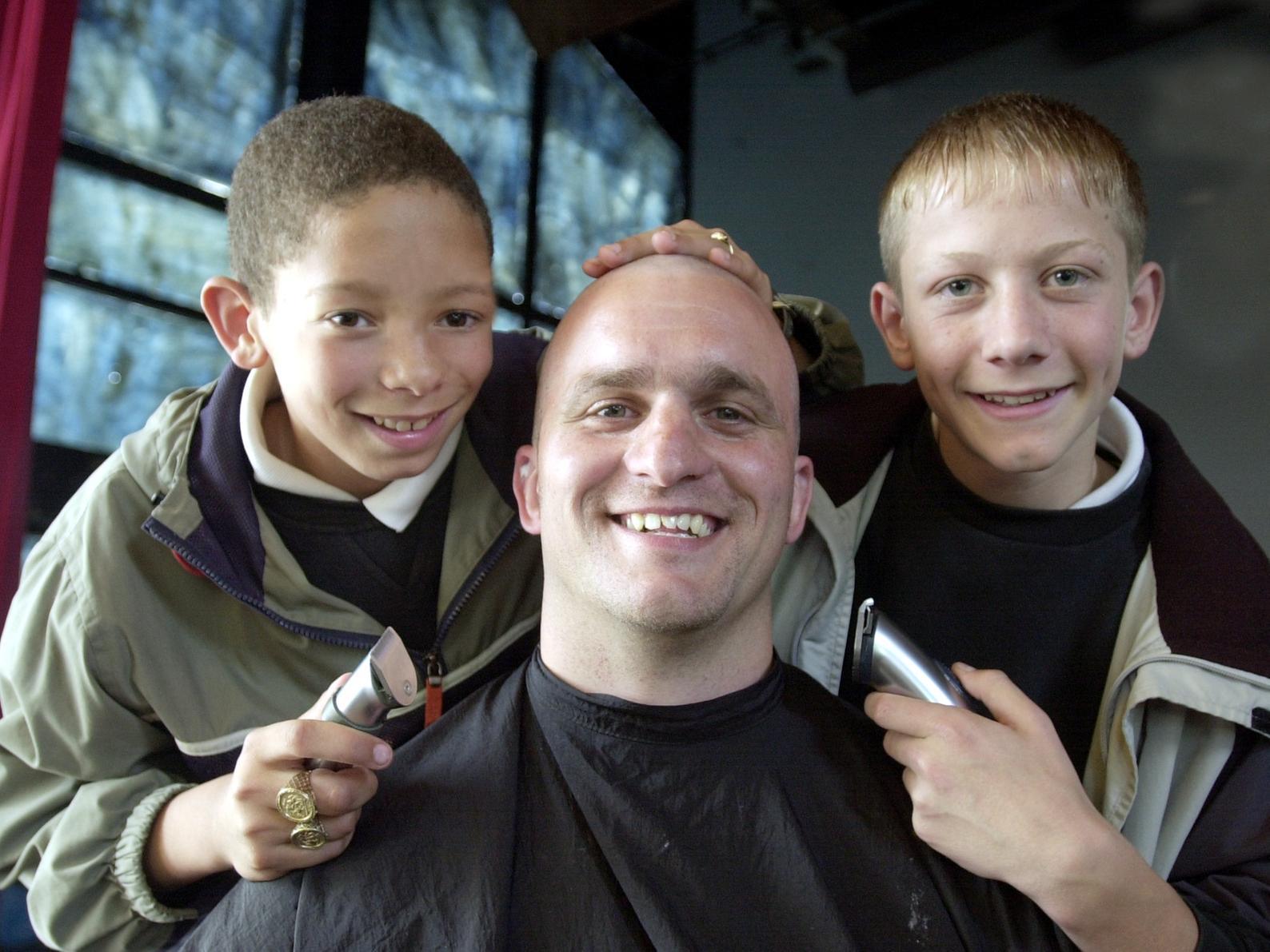 Jason Kennerlley has his head shaved with the help of Carl Tudor and Sam Fella to raise funds for the school's rugby tour.