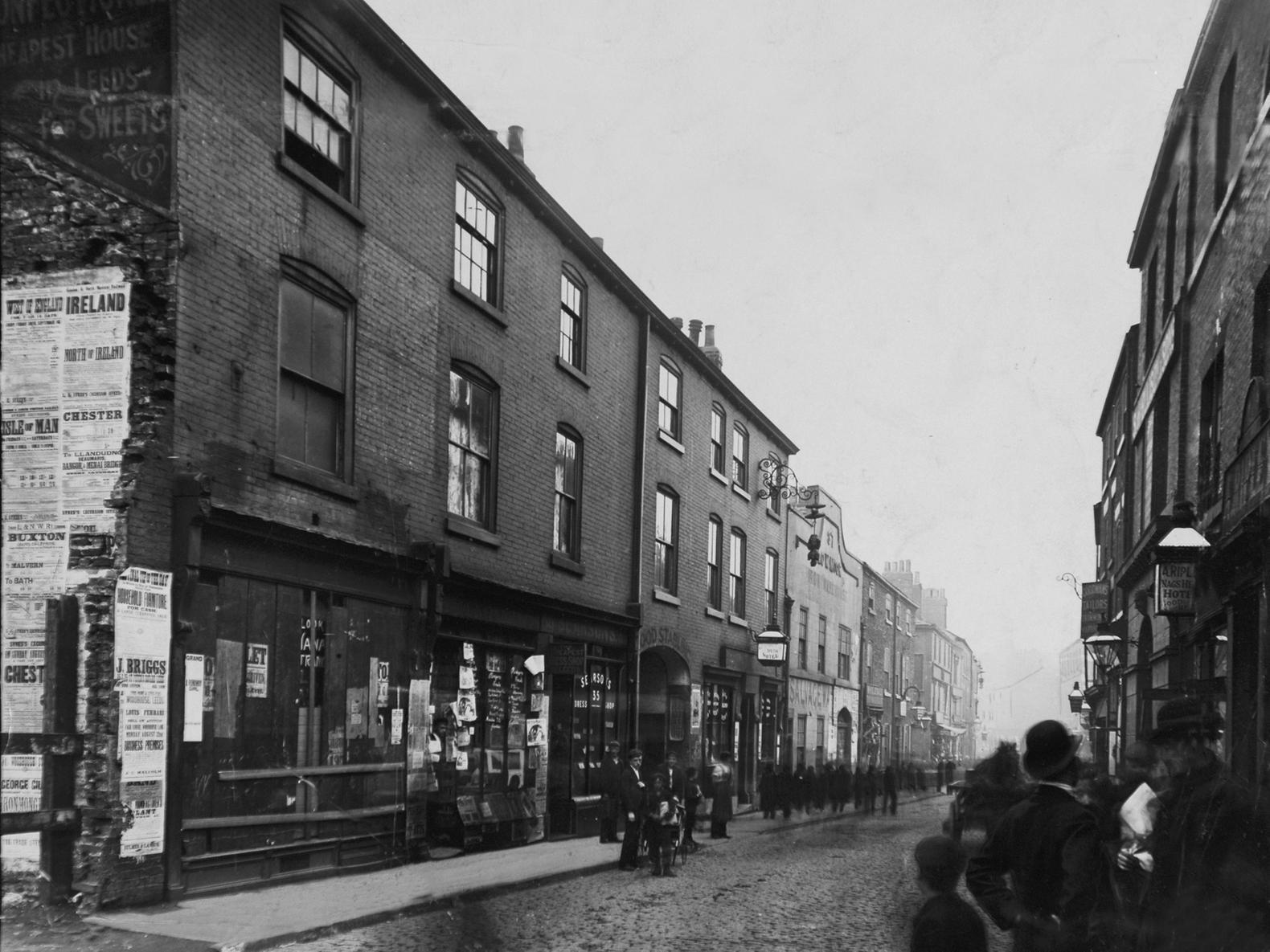 Vicar Lane when it was a much narrower cobbled thoroughfare. The Nag's Head Hotel sign can be seen on the right.