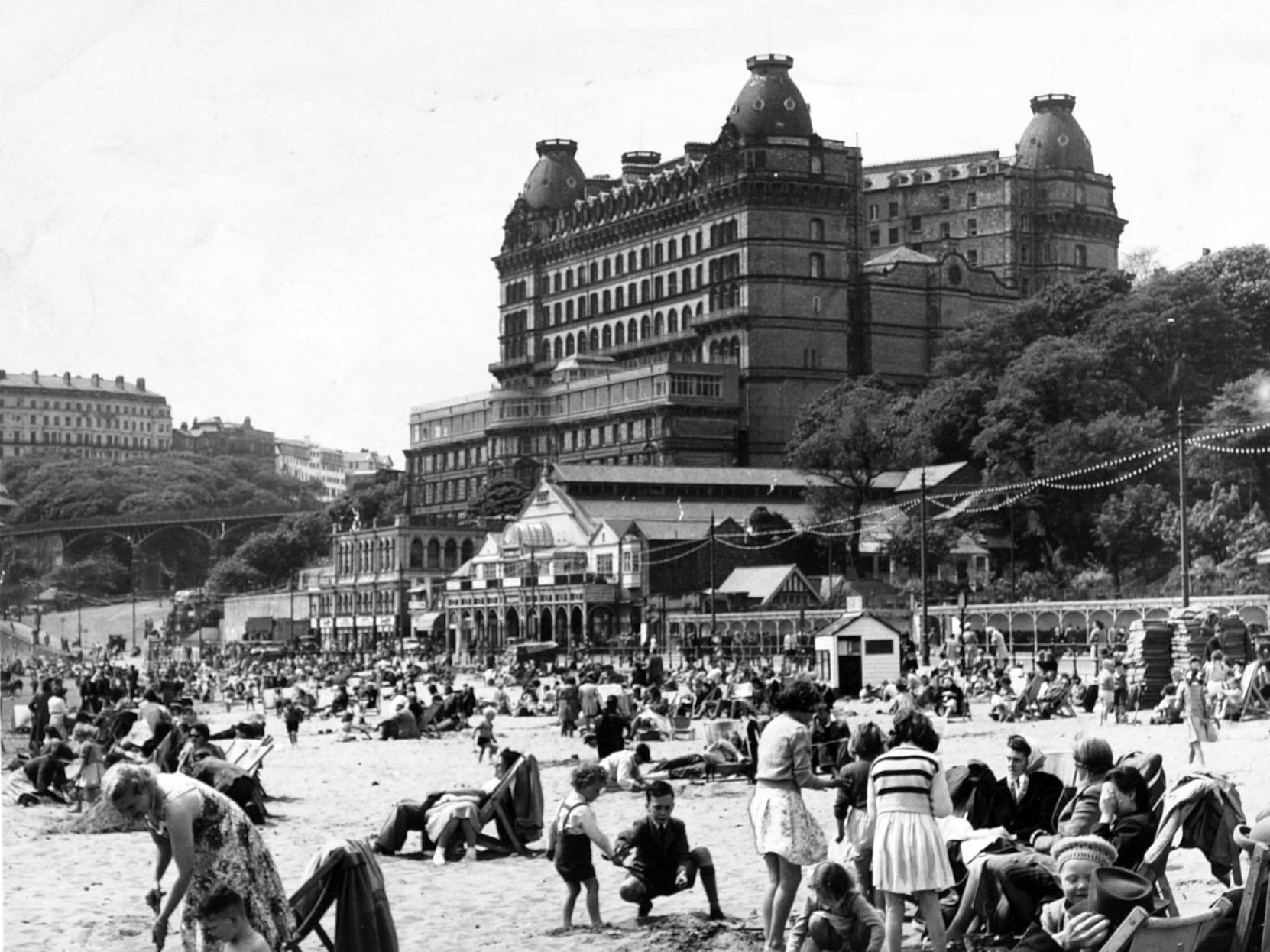 South Bay is busy and the Grand Hotel can be seen, as well as buildings which would go on to be replaced by Olympia amusements.