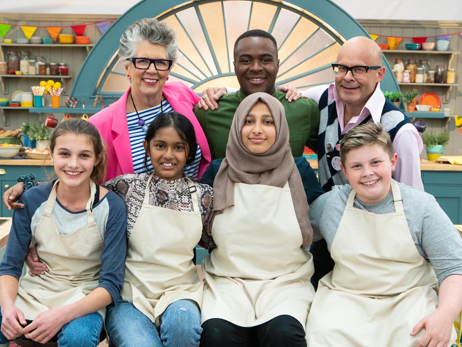 Prue Leith, Liam Charles and Harry Hill stand behind, from left, finalists Eliza, Amal, Aleena and Fin.