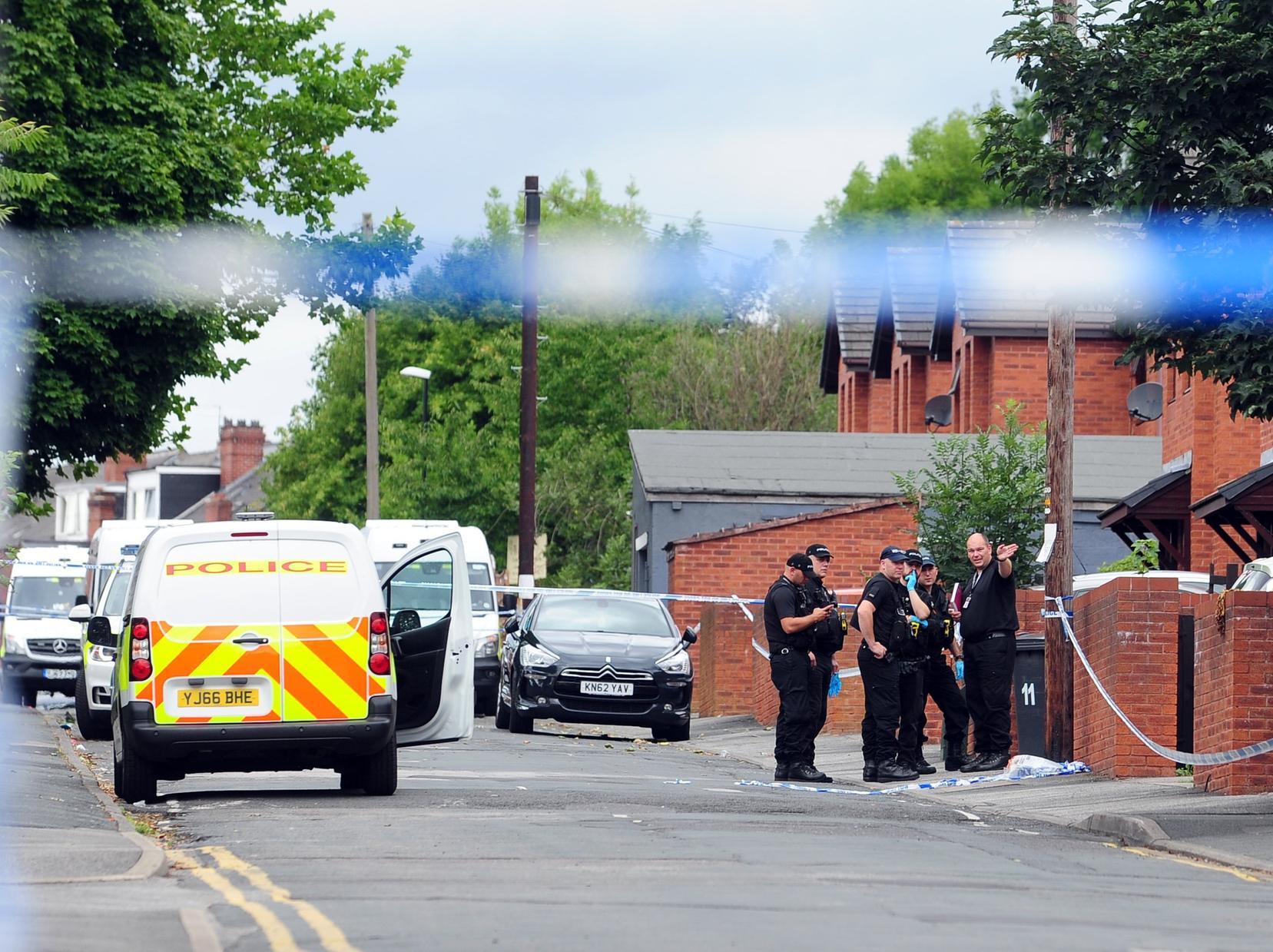 Police at the crime scene following the murder of Christopher Lewis on Reginald Street, Chapeltown.