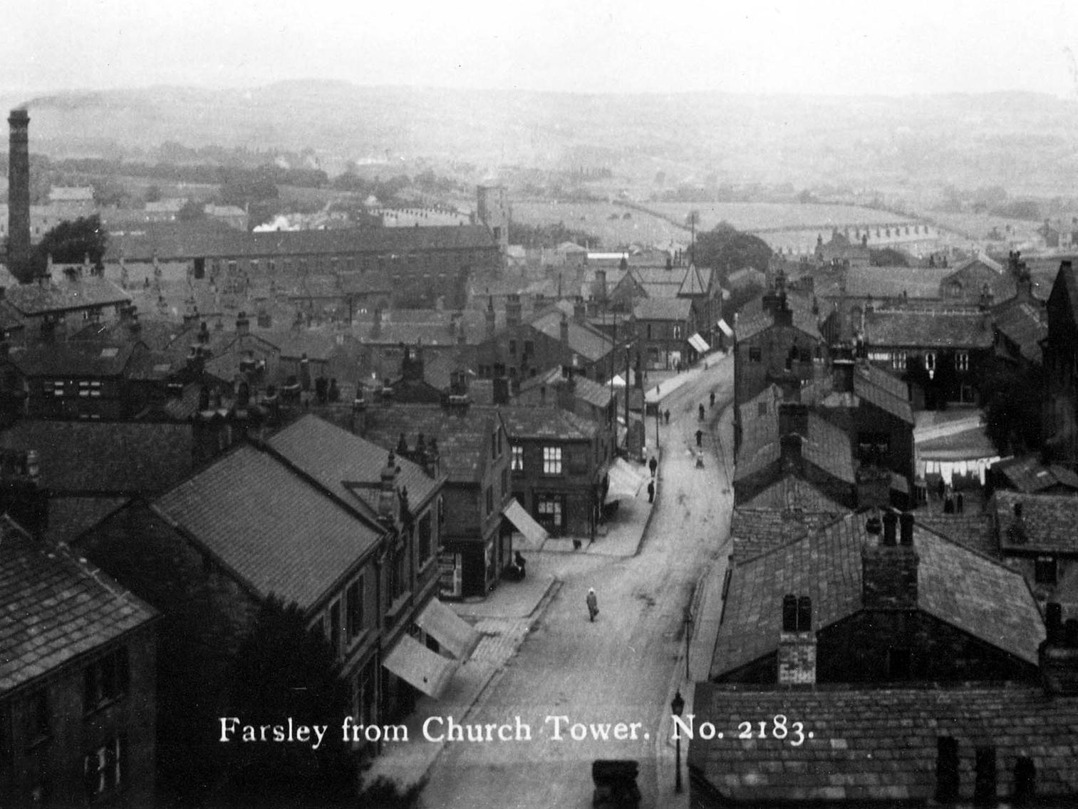 A view looking along Farsley Town Street, taken from St. John's Church Tower. The tall chimney on the left of the picture belongs to Sunny Bank Mills.