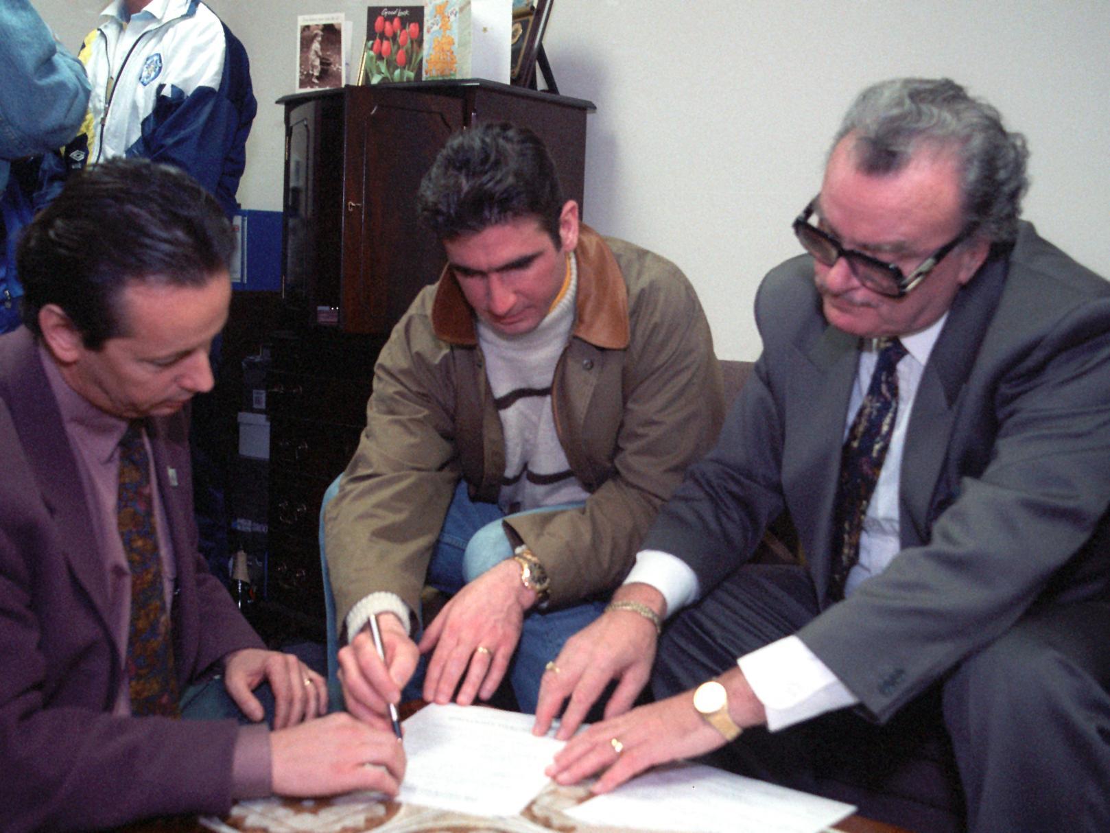 Eric Cantona signs for Leeds United. He is pictured with managing director Bill Fotherby (right) and his French agent.