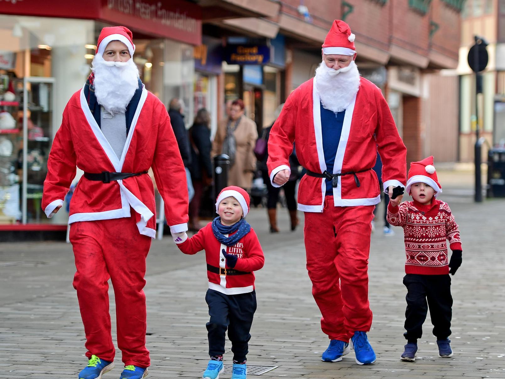 These mini-me's help their Santa's to the finish line.
