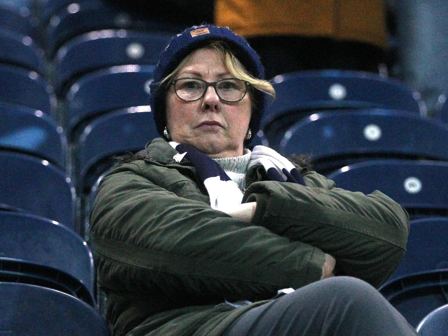 This North End fan looks stern faced as they wait for the game.