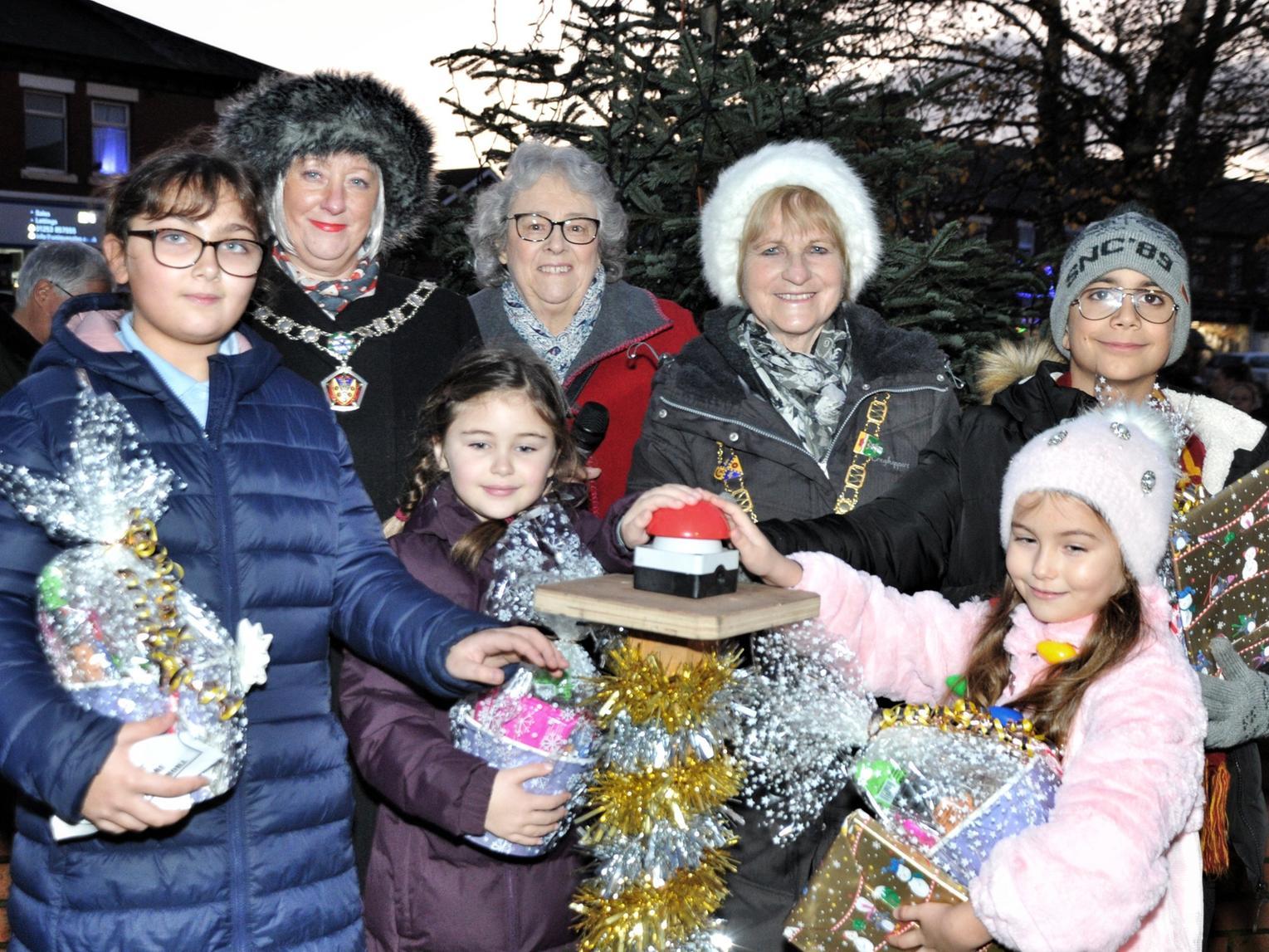 The Mayor and Mayoress are joined by Jenie Phillips and children who entered a competition to switch on the lights